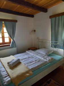 a bedroom with a large bed with a blue canopy at Pension Sava Turizam in Lonja