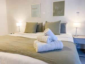 1 dormitorio con 2 toallas en una cama en Bravo Suites en el casco histórico de Salta, p/ 2. en Salta