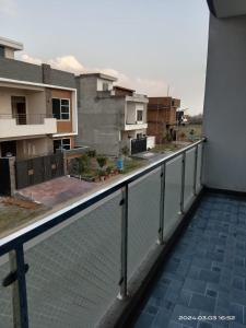 a balcony with a fence and some buildings at Edge of Islamabad Entrance in Islamabad