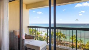 a room with a balcony with a view of the ocean at Luxury Oceanfront 2 Bedroom Apartment at Waikiki Beach Tower in Honolulu