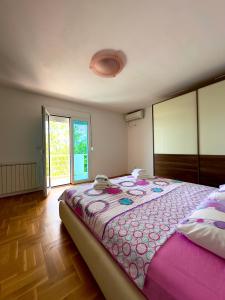 a bedroom with a large bed and a large window at Villa ELLA in Bar