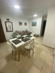 a living room with a table and chairs and a couch at Departamento Gastón in Posadas