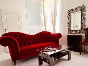 a red couch in a living room with a table at Sopot Spa Apartament in Sopot