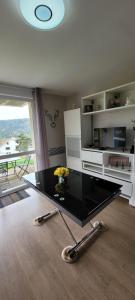 a living room with a table with flowers on it at Le Petit Sapin in Xonrupt-Longemer