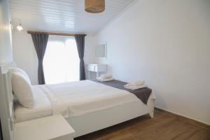 A bed or beds in a room at LONDİA OTEL