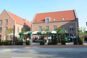 a group of people standing outside of a building at Hotel Am Markt in Heek