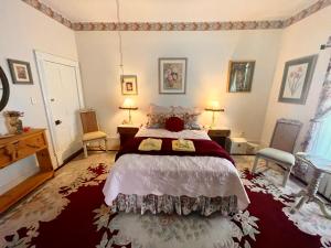 a bedroom with a large bed and two chairs at Irishette - Charming Suite in 1893 Victorian Home in Dublin