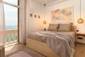 a bedroom with a bed with a view of the ocean at Apartment Mama Marija in Hvar