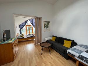 a living room with a couch and a bed at Apartmán s výhledem na zámek I in Vimperk