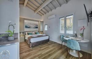 a bedroom with a bed and a table and a desk at FORESTERIA GUESTHOUSE CA' DEI BACHITT in Lierna