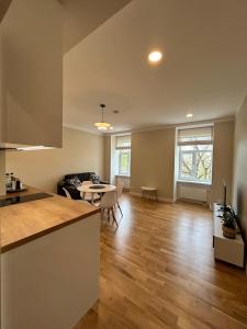 a kitchen and living room with a table and chairs at Pine cone cozy apartment in Rīga