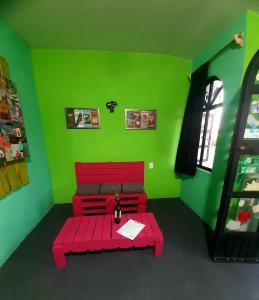 a room with a red bench in a green room at Huerto en el Barrio in Guadalajara