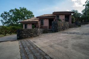 a small house with a stone wall at Borgata Baldazza in Linguaglossa