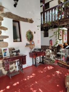 a living room with a red carpet and a staircase at Casablanca Ollantaytambo in Ollantaytambo
