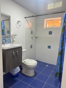 a bathroom with a toilet and a sink at Leonor’s Guest House in Providencia