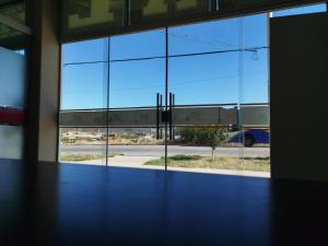 an empty room with a view of a large window at HOSTAL GALO in Tarija