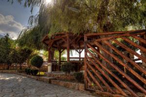 a wooden gate in front of a pavilion at Petrina House in Angistron