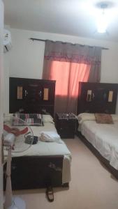 a bedroom with two beds and a window at Lasirena mini egypt elsokhna in Ain Sokhna