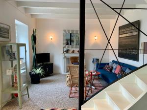 a living room with a blue couch and a table at L 'Air Yaudet in Becléguer