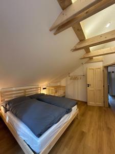 a bedroom with a large bed in a attic at Apartmány a chata MONTANUS in Malá Morávka