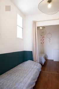 a bedroom with two beds and a window at T2 La Joliette, 13002 Marseille in Marseille