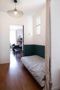 a bedroom with a bed and a living room at T2 La Joliette, 13002 Marseille in Marseille