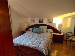 a bedroom with a bed with a blue comforter at Apartamento Loft A Estivada in Rosal