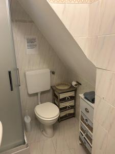 a small bathroom with a toilet and a staircase at Appartamento in tipico carugio ligure in Monterosso al Mare +7 photos