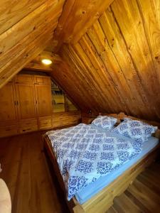 a bedroom with a bed in a wooden attic at Chata Valika Jezersko in Jezersko