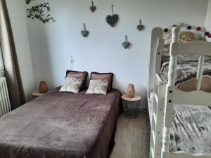 a bedroom with a bed and two bunk beds at Villa La Faute-sur-Mer in La Faute-sur-Mer
