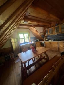 a kitchen with a wooden table with two teddy bears on it at Chata Valika Jezersko in Jezersko