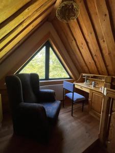 a room with a chair and a desk in a attic at Chata Valika Jezersko in Jezersko
