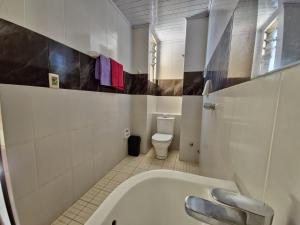 a bathroom with a tub and a toilet at HOSTAL GALO in Tarija