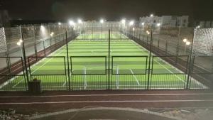 an empty tennis court at night with lights at Lasirena mini egypt elsokhna in Ain Sokhna