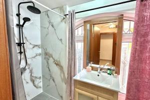 a bathroom with a sink and a shower at Studio in the center with BBQ Patio and parking in Nahariyya +7 photos