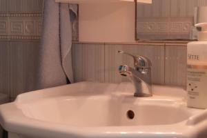 a bathroom sink with a bottle of soap on it at Villa Belvedere Flogita in Flogita +36 photos