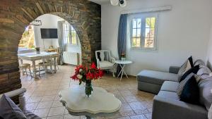 a living room with a couch and a table at Anoi House by the sea Agios Fokas Tinos in Tinos Town