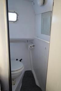 a small bathroom with a toilet and a window at Night at sea Puerto Calero in Puerto Calero