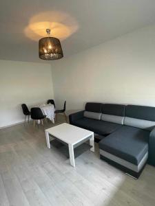 a living room with a couch and a table at Jagiellonka in Malbork