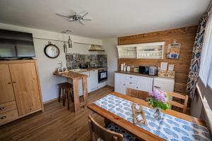 a kitchen with a table and a dining room at Zacisze Pod Reglami in Zakopane