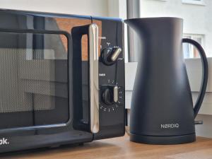 a coffee maker is next to a microwave at Hakuna Matata @ Opera in Antwerp
