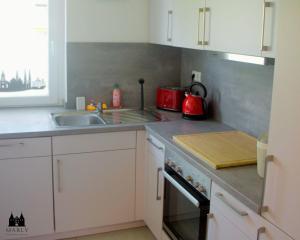 a kitchen with a sink and a stove top oven at Ferienwohnung Marly in Lübeck