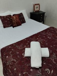 a bedroom with a large bed with towels on it at Araucaria in Oualidia