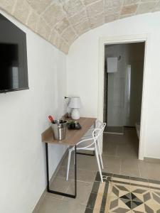 a room with a table with a lamp on it at Dimora Santa Teresa in Monopoli