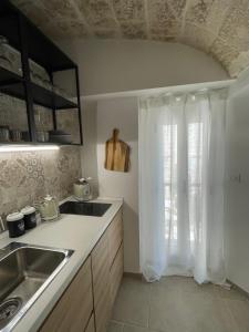a kitchen with a sink and a window at Dimora Santa Teresa in Monopoli +52 photos