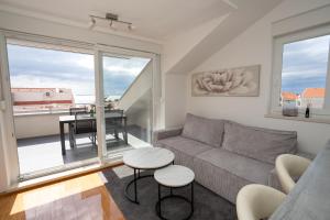 a living room with a couch and a table at Adriatic Escape Novalja-Zrce! in Novalja