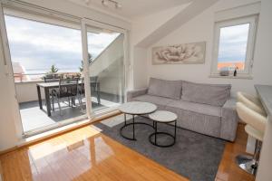 a living room with a couch and a table at Adriatic Escape Novalja-Zrce! in Novalja