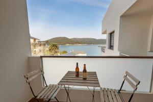 two bottles of beer sitting on a table on a balcony at Vicedo White Sand in O Vicedo