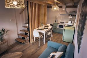 a living room with a blue couch and a table at Apartamento Villa Carlota in Cudillero