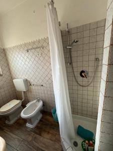 a bathroom with a toilet and a shower at Casa Vittoria in Palau +31 photos